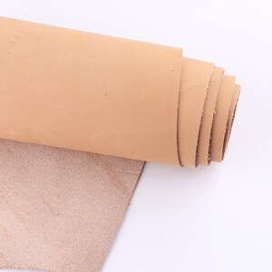 May include: A roll of light brown leather with a lighter brown suede side.