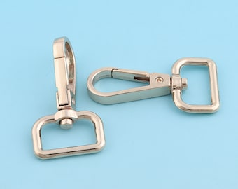 May include: Two silver metal swivel clasps with a rectangular loop on one end and a hook on the other end. The clasps are commonly used for attaching straps, leashes, or other accessories.