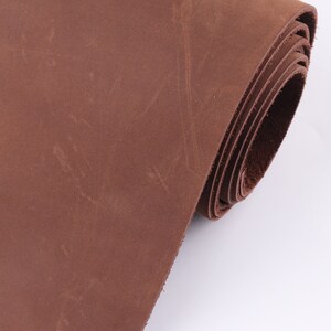 May include: A roll of brown leather, showing the texture and grain of the material.