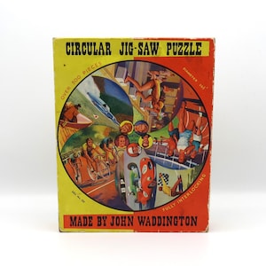 May include: A vintage circular jigsaw puzzle box with a colorful illustration of people participating in various sports and activities. The box is yellow with red and black accents. The text on the box reads "CIRCULAR JIG-SAW PUZZLE", "OVER 300 PIECES", "DIAMETER 10"