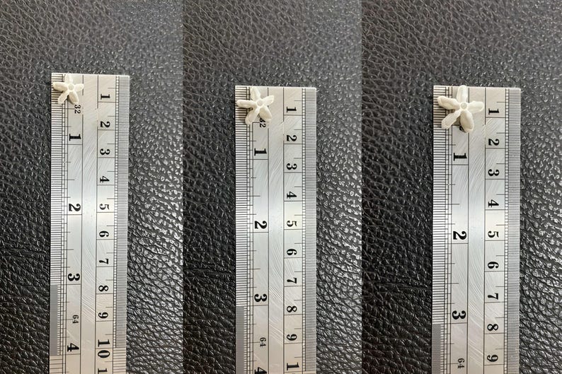 Measurement scale showing the exact size in millimeters for small, medium, and large white crown flower beads for precision craft projects.