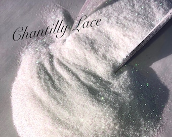 May include: White iridescent glitter with the text "Chantilly Lace" written in black cursive.