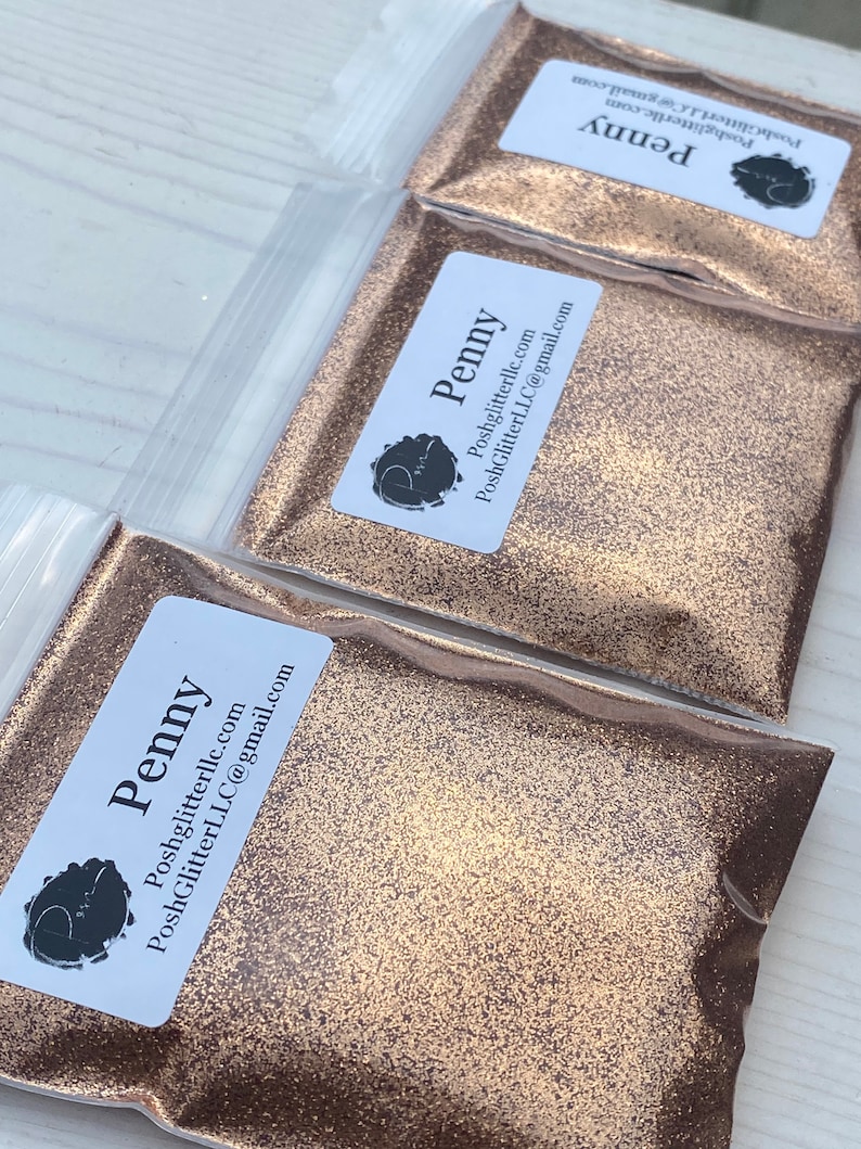 May include: Three small bags of gold glitter labeled "Penny" with the website and email address for PoshGlitterLLC.com.