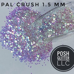 May include: Close-up of iridescent glitter, labeled "OPAL CRUSH 1.5 MM", scattered on a surface. The glitter is a mix of white, pink, and purple hues, with a clear container partially visible. A black circle with white text reads "POSH GLITTER LLC."