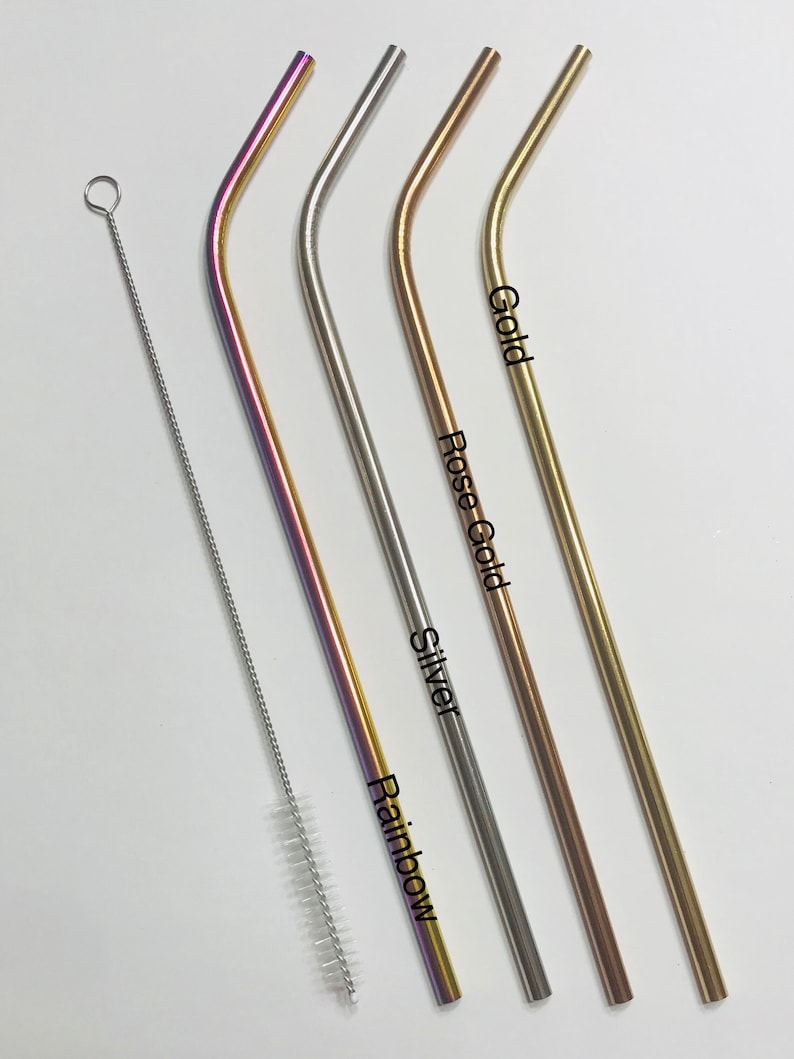 May include: Four metal drinking straws in different colors: rainbow, silver, rose gold, and gold. The straws are bent and have a cleaning brush next to them.