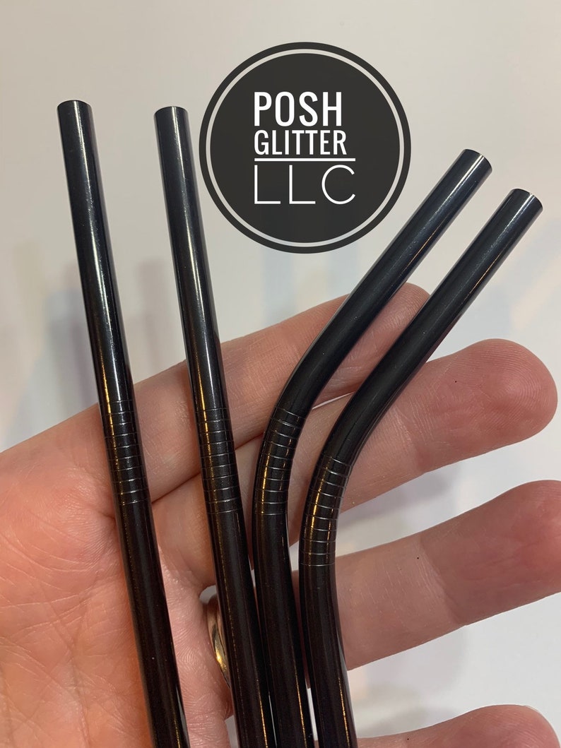 May include: Four black metal reusable drinking straws. The straws are bent at the top and have a textured surface.