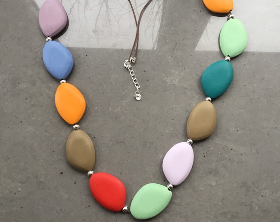 Long lagenlook necklace, with multi coloured oval discs, with double black suede thread.