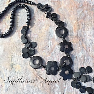 Wooden beaded and disc necklace, with coconut shell tassels. On double string threads.