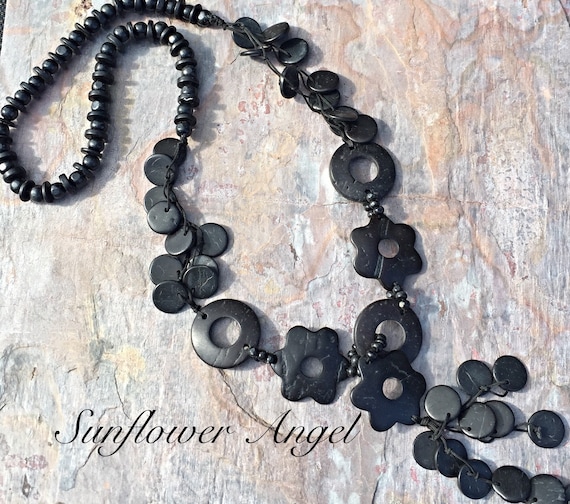 Wooden beaded and disc necklace, with coconut shell tassels. On double string threads.