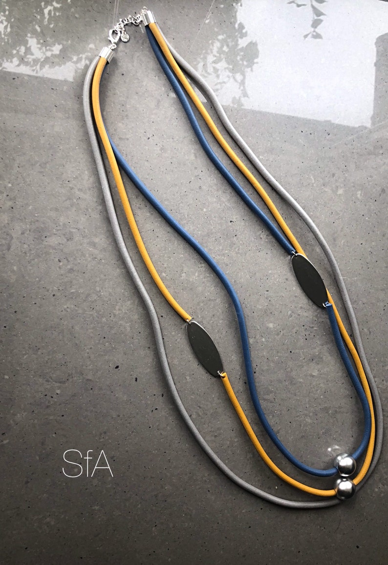 Rubber necklace lagenlook statement Caramel and teal threads with large orange disc.