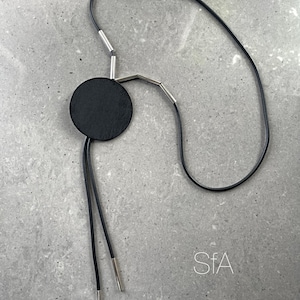 Black rubber necklace, with wooden round disc shapes. Lightweight