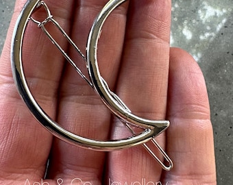 Crescent moon hair clip on a polished silver or gold style clip frame.