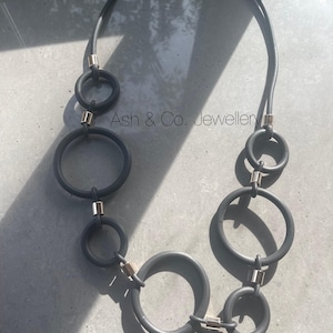 Thick black foam rubber necklace, with matching descending circles.