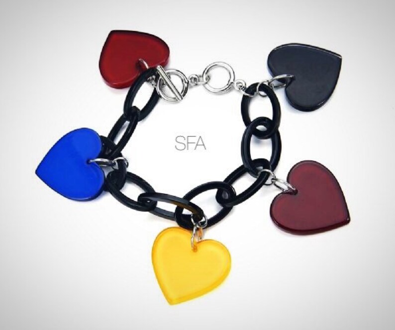Circle and bar fastener. The Ashi acrylic black bracelet with multicoloured hearts