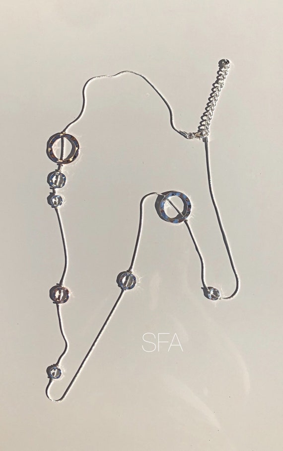 Wow, geo circle necklace, with various shapes circles on a snake chain, with silver and rose gold circles.