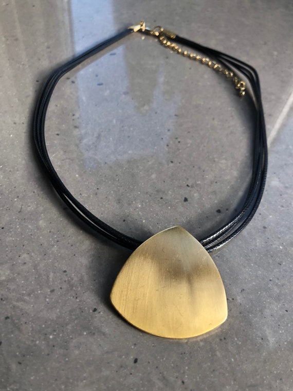 The Gilda gold brushed heart necklace, on multi coated cord threads.