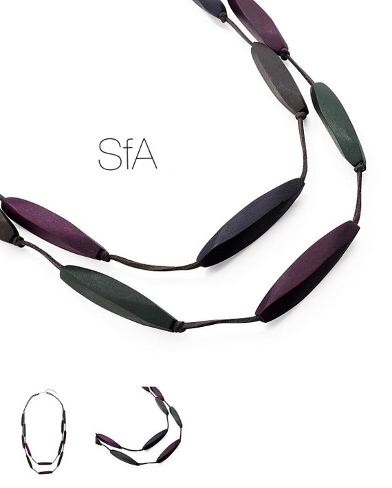 Long necklace made from purple, brown and green wooden cones, with double suede thread.