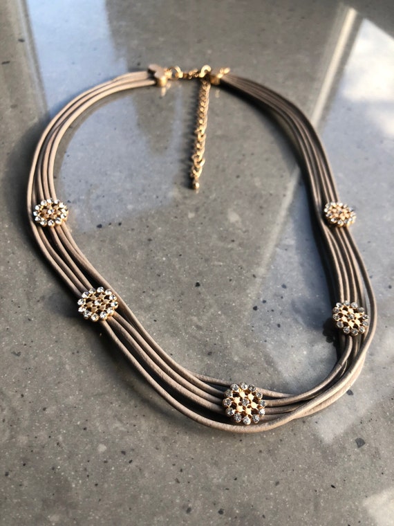 The Marla short taupe necklace, with 5 multi strand necklace with frosted gold and crystal flowers