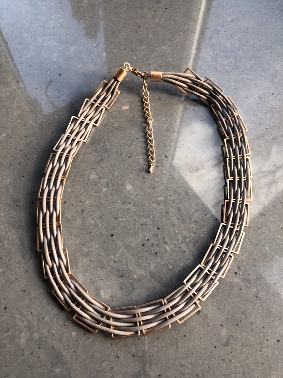 The Zoe multithread gold caged taupe necklace.