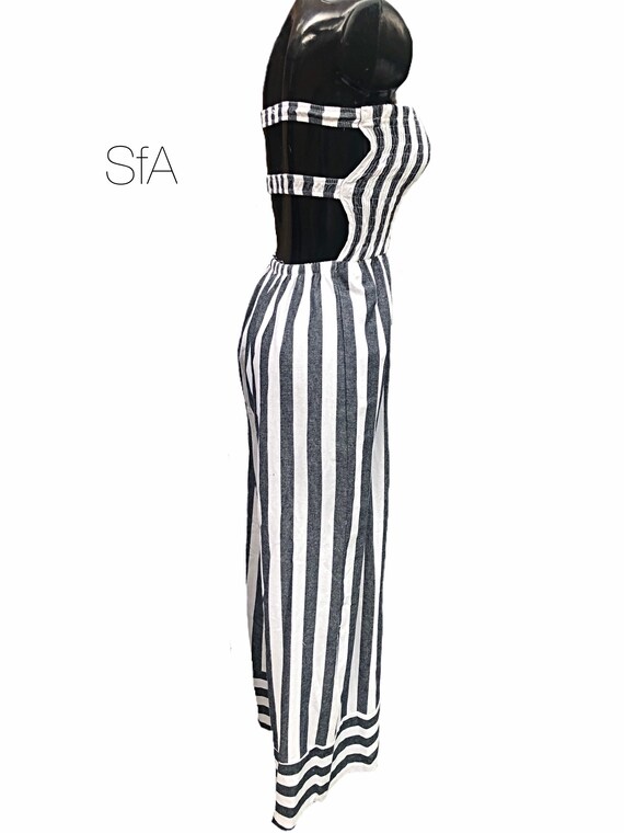 Denim blue and white striped jumpsuit with flared trousers and double strap back. Size 8-12