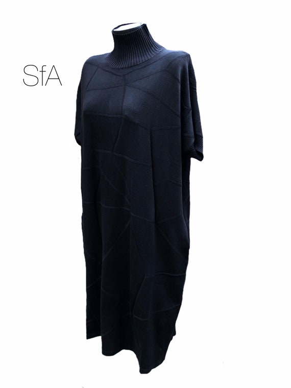 Black dress by Neslay. In black with turtle neck, short sleeves, perfect with boots or heels XXL