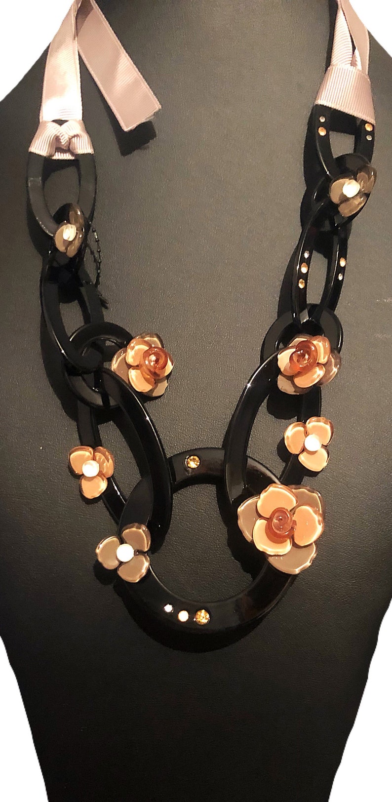 The Leila acrylic black and taupe flower acrylic circular necklace with ribbed ribbon tie