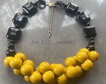 Fabulous chunky acrylic necklace in deep yellow and black.