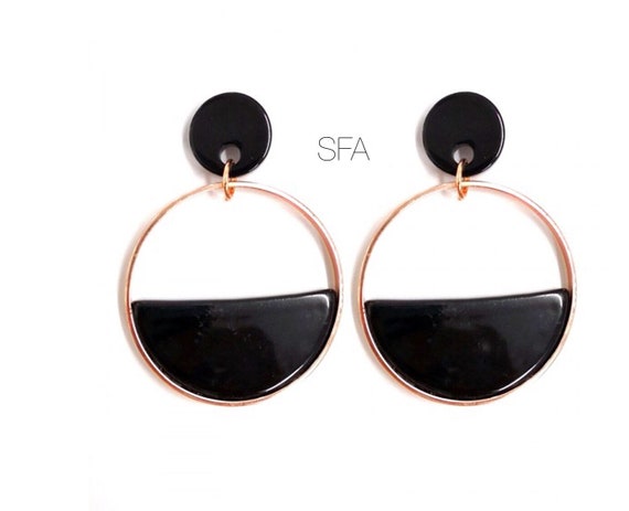 Geo black acrylic earrings. Surrounded in gold, for pierced ears