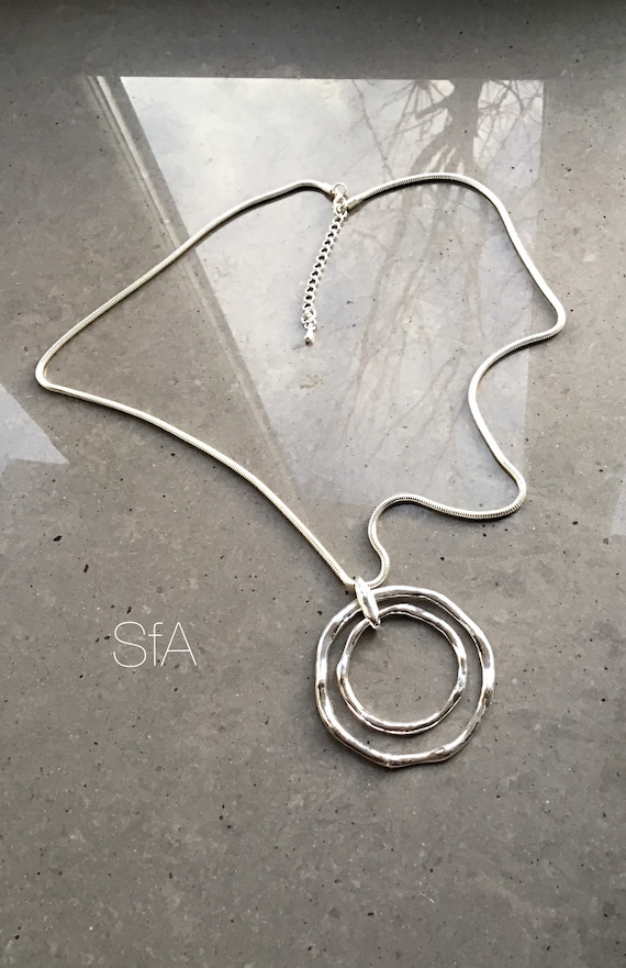 Lagenlook abstract necklace, with double round pendant, on a long snake chain.