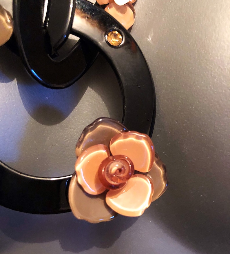 The Leila acrylic black and taupe flower acrylic circular necklace with ribbed ribbon tie