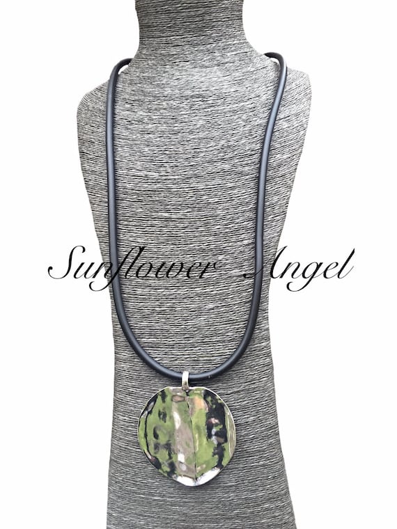 Large lagenlook stainless disc on long thick black rubber cord, lobster clasp.