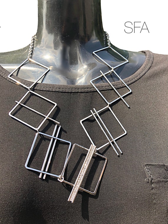 Geo metric necklace, lagenlook necklace, in silver tone. With diamate strip, in either squares or circles. Mid length