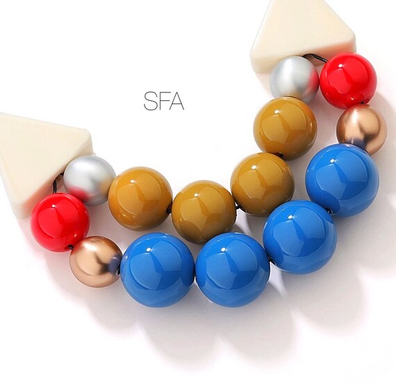 WoW double stranded rubber necklace with multi coloured acrylic beads.