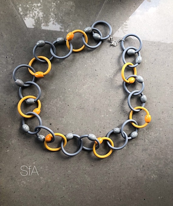 Lagenlook, Geo, multi thread rubber necklace, in yellow and grey circles, with orange and grey beads. Last one