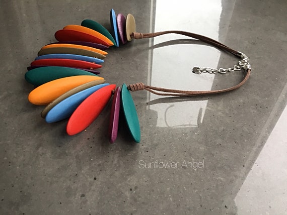 Lagenlook necklace, row of rainbow tear shaped wooden discs. On a double brown sude cord.