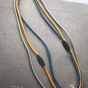 Rubber necklace, lagenlook statement. Caramel and teal threads with large orange disc.