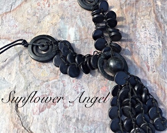 Black Wooden beaded and disc necklace, with cocnut shell tassels. On double string threads.