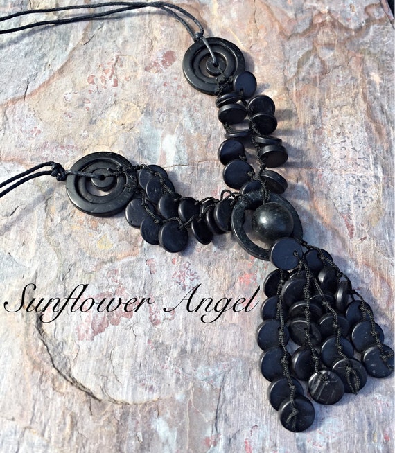 Wooden beaded and disc necklace, with cocnut shell tassels. On double string threads.