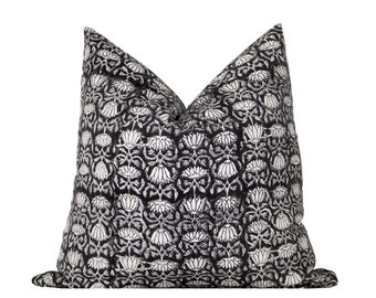May include: Black and white patterned throw pillow with a floral design.