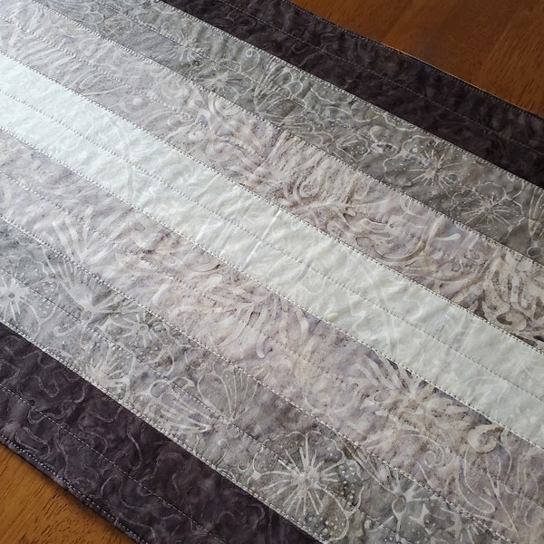 Modern quilted batik table runner, linear value gradations of grey and black