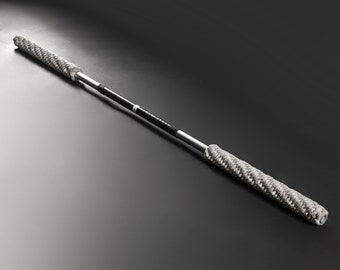 May include: A silver and black martial arts staff with a braided grip. The staff is about 5 feet long.