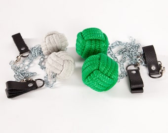 May include: Two pairs of fire poi, one pair is green and the other is white. The poi are attached to chains with leather wrist straps.