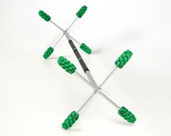 May include: A silver cleaning tool with six green cleaning heads attached to the ends of the arms. The tool is designed to clean hard-to-reach areas.