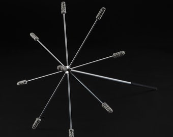 May include: A silver cleaning tool with eight gray cleaning brushes attached to the ends of the arms. The tool has a black handle.