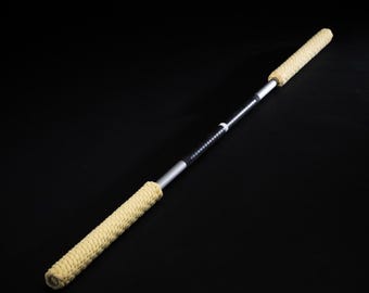 May include: A pair of black and silver fire staffs with yellow rope handles. The staffs are made of metal and have a black grip.