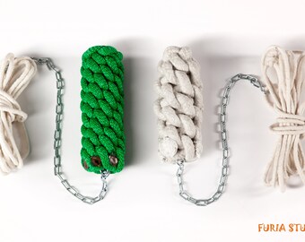 May include: Three dog toys, one green, one white, and one white rope. Each toy has a metal chain attached.