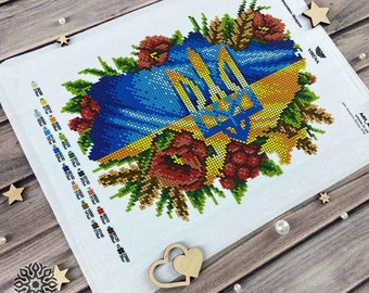 May include: A diamond painting kit featuring a Ukrainian flag with a wreath of flowers and wheat. The kit includes a canvas, beads, and instructions. The text on the canvas reads "Glory to Ukraine!"