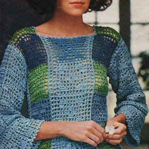 May include: A blue, green, and white crocheted top with a square pattern. The top has a tie at the waist and bell sleeves.