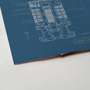 May include: A blueprint style illustration of a device with the text "TOP / BODY" and "NOT TO SCALE" in yellow. The device is labeled with various components, including "ACCU-SENSE ENABLE", "COOLING VENT", "PROCESSOR MODULE", "FAST TANK PRESSURE", "ANTI-GRAVITY RESISTOR", and "TENSION DAMPER".