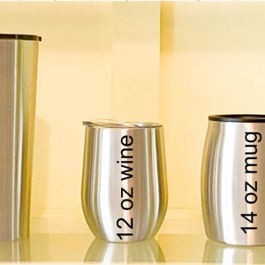 May include: Three stainless steel tumblers with black lettering. The tumblers are labeled "24 oz taper", "12 oz wine", and "14 oz mug".